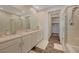 Bright bathroom featuring dual sinks, tile floor, separate tub, and glass-enclosed shower, and walk-in closet at 25 Barbara Ln # 67, Las Vegas, NV 89183