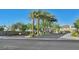 Inviting community entrance with desert landscaping and palm trees at 25 Barbara Ln # 67, Las Vegas, NV 89183