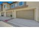 Attached garage offers convenient parking with neutral-colored doors, enhancing the curb appeal of the property at 25 Barbara Ln # 67, Las Vegas, NV 89183