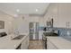 Bright kitchen featuring stainless steel appliances, quartz countertops, and stylish blue tile backsplash at 25 Barbara Ln # 67, Las Vegas, NV 89183