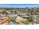 Wide aerial view of neighborhood homes with pools and mature trees, featuring cityscape in background at 2711 Ashby Ave, Las Vegas, NV 89102