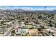 Wide aerial view of neighborhood homes with pools and mature trees, featuring mountains in background at 2711 Ashby Ave, Las Vegas, NV 89102