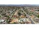 Wide aerial view of neighborhood homes with pools and mature trees, featuring mountains in background at 2711 Ashby Ave, Las Vegas, NV 89102