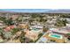 Wide aerial view of neighborhood homes with pools and mature trees, featuring mountains in background at 2711 Ashby Ave, Las Vegas, NV 89102