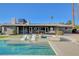 Backyard oasis with a sparkling pool, relaxing spa, chic lounge chairs, and verdant landscaping at 2711 Ashby Ave, Las Vegas, NV 89102