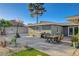 An outdoor patio area featuring a dining table, basketball hoop, and tasteful landscaping at 2711 Ashby Ave, Las Vegas, NV 89102