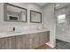 Bathroom featuring double vanity, shower, and stylish gray wood cabinets at 2711 Ashby Ave, Las Vegas, NV 89102