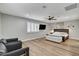 Well-lit bedroom with wood floors, ceiling fan, and comfortable seating area at 2711 Ashby Ave, Las Vegas, NV 89102