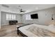 Comfortable bedroom featuring wood floors, ceiling fan, and a large window at 2711 Ashby Ave, Las Vegas, NV 89102