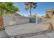 Spacious driveway secured by a metal gate and a well-maintained block wall for privacy at 2711 Ashby Ave, Las Vegas, NV 89102