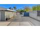 Wide driveway with a metal gate and painted blue design offering privacy and security at 2711 Ashby Ave, Las Vegas, NV 89102