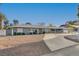 Charming single-story home with a well-manicured lawn and a curved driveway creates welcoming curb appeal at 2711 Ashby Ave, Las Vegas, NV 89102