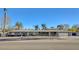 Wide shot of a well maintained, single-story home featuring mature landscaping and a two-car garage at 2711 Ashby Ave, Las Vegas, NV 89102