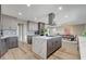 Contemporary kitchen featuring an island with a cooktop, stainless appliances, and dining area at 2711 Ashby Ave, Las Vegas, NV 89102