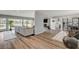 Open-concept living room featuring wood floors, large windows and sliding doors to the backyard at 2711 Ashby Ave, Las Vegas, NV 89102