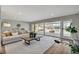 Bright living room featuring a plush sofa, modern coffee table, and sliding glass doors to the outdoor space at 2711 Ashby Ave, Las Vegas, NV 89102