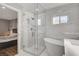 Luxurious main bathroom with marble walls, glass shower, soaking tub, and modern fixtures at 2711 Ashby Ave, Las Vegas, NV 89102