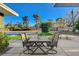 Outdoor dining area with a patio set overlooking the pool and lush landscaping at 2711 Ashby Ave, Las Vegas, NV 89102