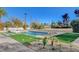 Scenic backyard featuring a sparkling pool with integrated spa, complemented by a modern landscaped patio and lounge chairs at 2711 Ashby Ave, Las Vegas, NV 89102