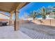 Relaxing covered patio with tan columns overlooks the low maintenance backyard and BBQ grill at 2714 Thomasville Ave, Henderson, NV 89052