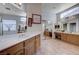 Bright bathroom boasting double sinks with wooden cabinetry, tile floors, and large mirrors at 2714 Thomasville Ave, Henderson, NV 89052