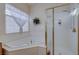 Bathroom showcasing a tub with gold fixtures next to a glass shower at 2714 Thomasville Ave, Henderson, NV 89052