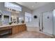 Well-lit bathroom featuring double sinks, a corner tub, and a walk-in glass shower at 2714 Thomasville Ave, Henderson, NV 89052