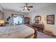 Cozy bedroom features a ceiling fan, wood furniture, and natural light from the window at 2714 Thomasville Ave, Henderson, NV 89052