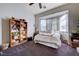 Cozy bedroom with a bay window, neutral tones, and carpeted floors at 2714 Thomasville Ave, Henderson, NV 89052