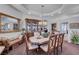 Elegant dining room featuring a large wooden table, ornate hutch, and tray ceiling at 2714 Thomasville Ave, Henderson, NV 89052