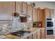 Kitchen featuring stainless steel appliances, granite countertops, and tile backsplash at 2714 Thomasville Ave, Henderson, NV 89052