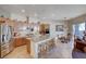 Eat-in kitchen featuring stainless steel appliances, granite countertops, and a center island with barstool seating at 2714 Thomasville Ave, Henderson, NV 89052