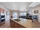 Open-concept kitchen featuring stainless steel appliances, granite countertops, and views into the living room at 2714 Thomasville Ave, Henderson, NV 89052