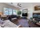 Comfortable living room featuring a fireplace, a large TV and soft carpeting at 2714 Thomasville Ave, Henderson, NV 89052