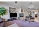 Living room featuring a cozy fireplace, skylight, and inviting seating at 2714 Thomasville Ave, Henderson, NV 89052