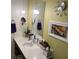 Bright bathroom with quartz countertop vanity, wall mirror, and modern lighting fixtures at 29 Montelago # 108, Henderson, NV 89155