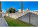 Backyard showing block wall and lush green lawn at 2974 Lindell Rd, Las Vegas, NV 89146