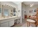 Bright vanity area adjacent to the bedroom features a large mirror, bright lights, and drawers at 2974 Lindell Rd, Las Vegas, NV 89146