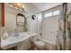 Bathroom features a decorative mirror and vanity with shower-tub combo at 2974 Lindell Rd, Las Vegas, NV 89146