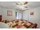 Cozy bedroom with a ceiling fan, a decorative quilt, and a window offering outdoor views at 2974 Lindell Rd, Las Vegas, NV 89146