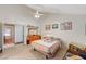 Well-lit bedroom with a vaulted ceiling, featuring a quaint quilt, dresser, and access to the bathroom at 2974 Lindell Rd, Las Vegas, NV 89146