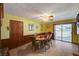 Bright dining room with wood paneling, tile floors, and sliding glass doors to the backyard at 2974 Lindell Rd, Las Vegas, NV 89146