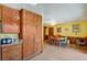 Open dining room with a view of the kitchen, featuring wood cabinetry at 2974 Lindell Rd, Las Vegas, NV 89146