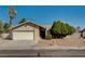 Charming single-story home featuring a well-maintained front yard, mature trees, and an attached two-car garage at 2974 Lindell Rd, Las Vegas, NV 89146