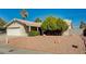 Charming single-story home featuring a well-maintained front yard, mature trees, and an attached two-car garage at 2974 Lindell Rd, Las Vegas, NV 89146