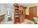 Hallway with built in shelves, wood cabinetry, and tile floors at 2974 Lindell Rd, Las Vegas, NV 89146