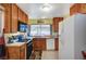 Functional kitchen featuring tile floors, wooden cabinets, and appliances at 2974 Lindell Rd, Las Vegas, NV 89146