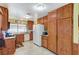 Functional kitchen featuring tile floors, wooden cabinets, and appliances at 2974 Lindell Rd, Las Vegas, NV 89146