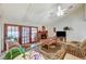 Bright living room featuring a vaulted ceiling, a cozy fireplace, and large windows, creating a comfortable and inviting space at 2974 Lindell Rd, Las Vegas, NV 89146