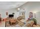 Bright living room featuring a vaulted ceiling, a cozy fireplace, and large windows, creating a comfortable and inviting space at 2974 Lindell Rd, Las Vegas, NV 89146